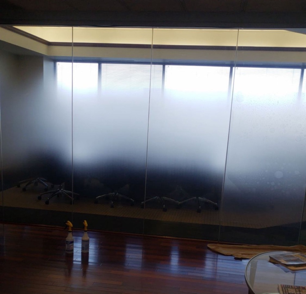 Glass conference room wall with gradient frosted privacy film