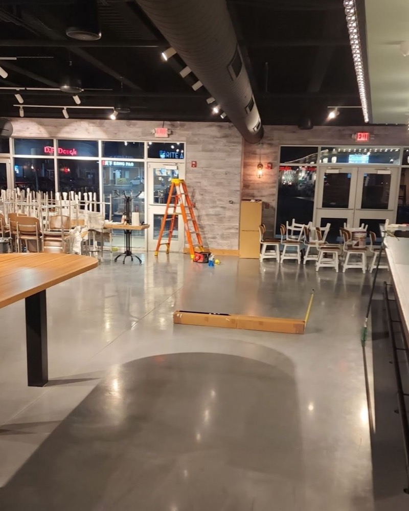 Inside a restaurant during a window tint install, ladder by the front windows