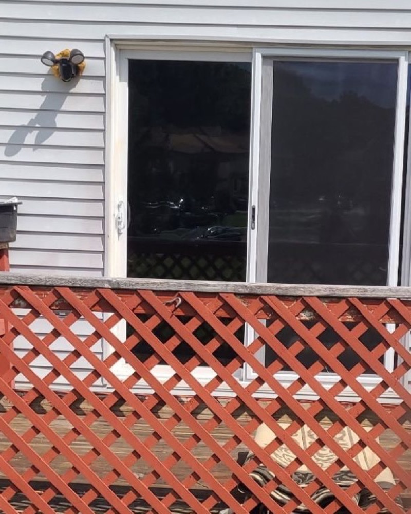 Exterior of a home showing a tinted sliding glass door
