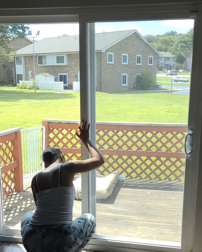 Installer applying window film to a sliding glass door